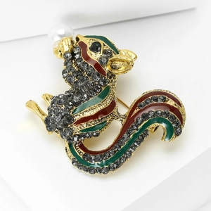 Elegant gold squirrel brooch with rhinestones, enamel finish and pearl on white steps