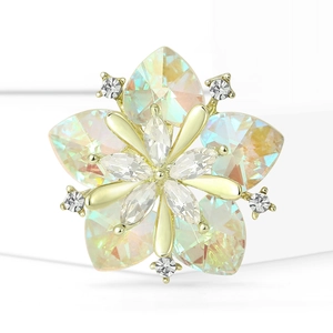 Macro shot of a luxury sunflower brooch with AB crystal hearts and golden metal petals