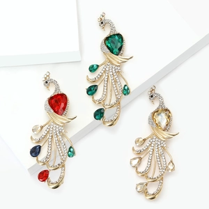 Elegant peacock brooch with sparkling rhinestones and colorful crystals on white pedestals
