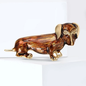 Detailed close-up of a golden poodle dog brooch with brown enamel and realistic hair texture