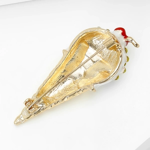 Detail view of the gold-plated alloy back and safety pin buckle on ice cream brooch