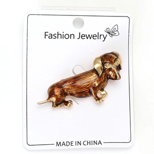 Close-up of a brown enamel dachshund dog brooch pin with detailed metallic alloy finish