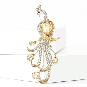 Elegant peacock brooch with champagne heart gemstone and crystals on golden finish