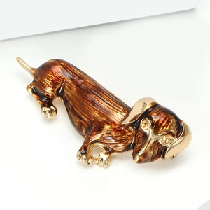 Minimalist dachshund dog brooch with golden alloy base and brown enamel texture