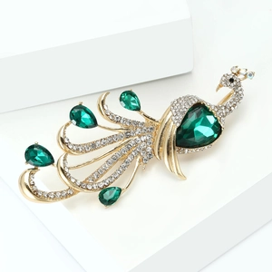 Detailed shot of peacock brooch with luxury green teardrop crystals and pavé diamonds