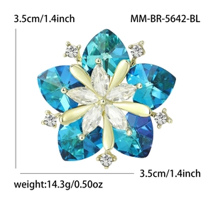 Elegant gold flower brooch with blue heart crystals and white marquise center stones