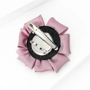 Detailed back view of pink purple fabric flower pin and hair clip with metal base