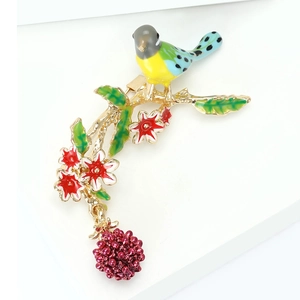 Detailansicht der farbenfrohen Emaille-Vogelbrosche mit grünen Blättern und Beeren