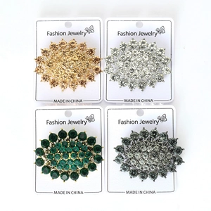Detailed close-up of oval alloy rhinestone brooches in four elegant metallic colors