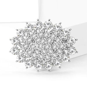Detailed close-up of luxury silver-tone brooch with radiant crystal rhinestones