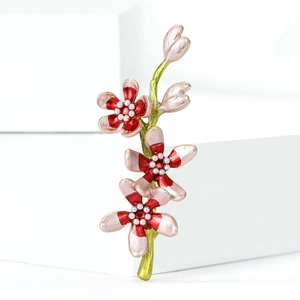 Elegant enamel peach flower brooch with pink petals and white pearl center on white block