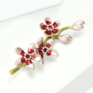 Detailed macro view of an elegant flower brooch with pink enamel petals and pearls