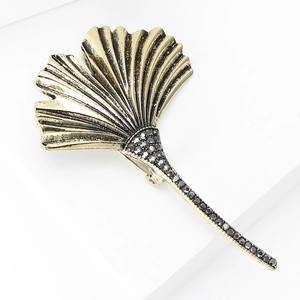 Macro shot of ginkgo leaf brooch featuring vintage gold alloy and black rhinestones