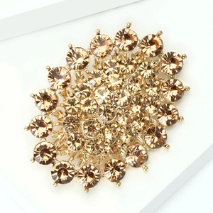 Macro detail of elegant champagne gold rhinestone brooch with intricate petal cluster design