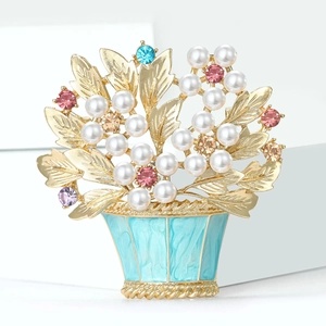 Elegant floral basket brooch with multi-color crystals and faux pearls on white background