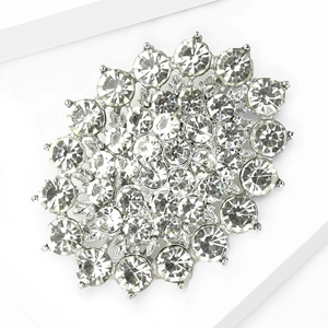 Macro shot of luxury silver alloy rhinestone bridal brooch on a geometric stand
