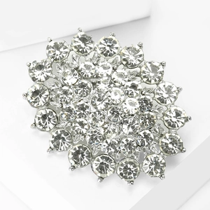 Detailed close-up of luxury bridal brooch with sparkling rhinestones on silver alloy
