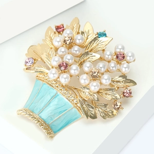 Detailed close-up of a floral basket brooch with blue enamel and sparkling crystals