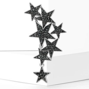 Star-shaped brooch with black pavé zircons and dangling star charm on white blocks