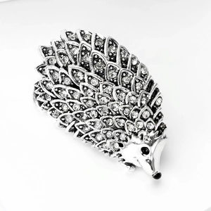 Close-up of silver hedgehog brooch showing intricate crystal pavé and metal details