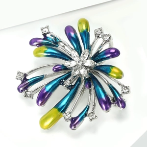 Detail of fireworks brooch with blue and purple enamel and sparkling zircon stones