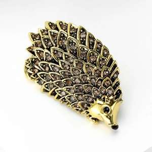 Detailed close-up of a gold hedgehog brooch with sparkling champagne crystals