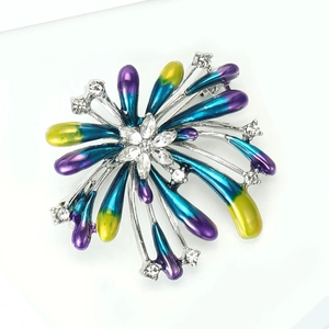 Close-up of alloy fireworks brooch with colorful enamel petals and sparkling crystals