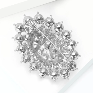 Macro view of the silver alloy brooch back featuring a secure metal safety pin clasp