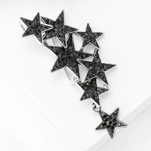 Detail shot of multi-star brooch with black rhinestones on minimalist white display