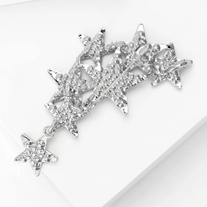 Detail of silver star brooch with rhinestone stars and a swinging star pendant