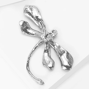 Close-up of the silver dragonfly brooch back featuring a secure pin clasp mechanism