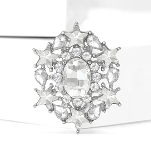 Detail shot of snowflake brooch with silver-tone base and clear inlaid crystals