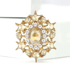 Detail of snowflake brooch with champagne stone and crystals on gold-plated base