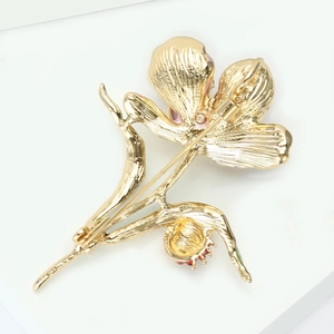 Detailed back view of vintage enamel lotus brooch showing golden metal texture and pin