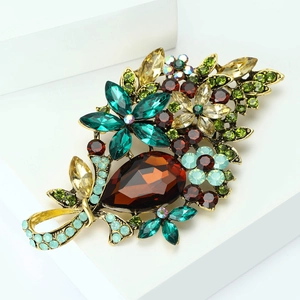 Detailed close-up of a vintage crystal flower brooch with amber water drop stone