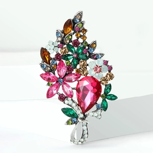 Detail of vintage flower brooch featuring colorful rhinestones on silver base
