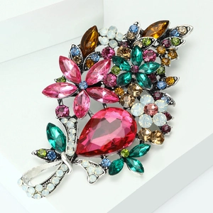 Detail of vintage flower brooch with multi-colored crystals on a silver alloy base