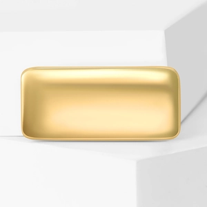 Macro shot of rectangular matte champagne gold metal jewelry tray with smooth rounded edges