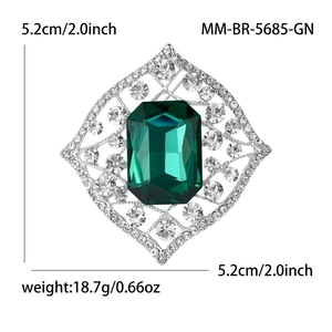 Vintage emerald-cut green crystal brooch with silver alloy frame and white rhinestones