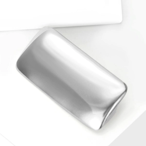 Detail of silver matte textured rectangular hair clip on white minimalist block