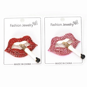 Detailed view of fashionable red and pink rhinestone lips brooches with cigarette motif