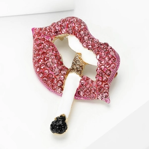 Macro shot of red lips biting a cigarette brooch with pink rhinestones and gold plating
