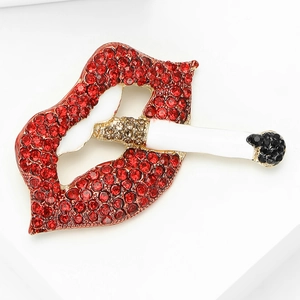 Detailed close-up of red lips and cigarette brooch with shiny rhinestones and enamel finish