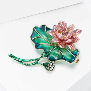 Detail of elegant lotus brooch featuring pink crystals green enamel and white pearls