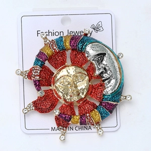 Detailed close-up of sun and moon brooch with colorful enamel and inlaid rhinestones