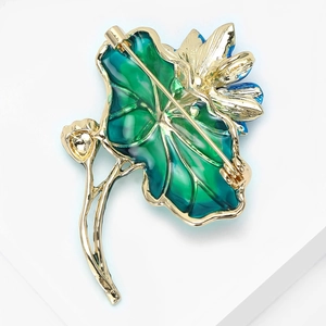 Close-up of brooch back showing the secure pin fastener and detailed gold metal craft