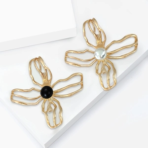 Elegant gold hollow camellia brooch set with black and white pearl accents for women