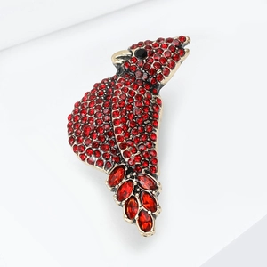 Sparkling red rhinestone bird brooch in vintage gold finish with black gemstone eye