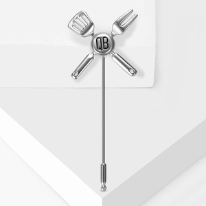 Silver cutlery brooch with crossed fork and shovel design featuring QB engraving