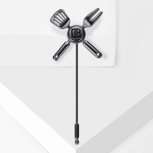 Enamel kitchenware brooch featuring chef tools and QB relief on dark metallic finish